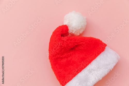 Simply minimal design Christmas Santa Claus hat isolated on pink pastel colorful trendy background