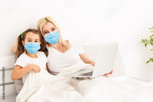 mother and daughter in protective mask at home. Healthcare concept.