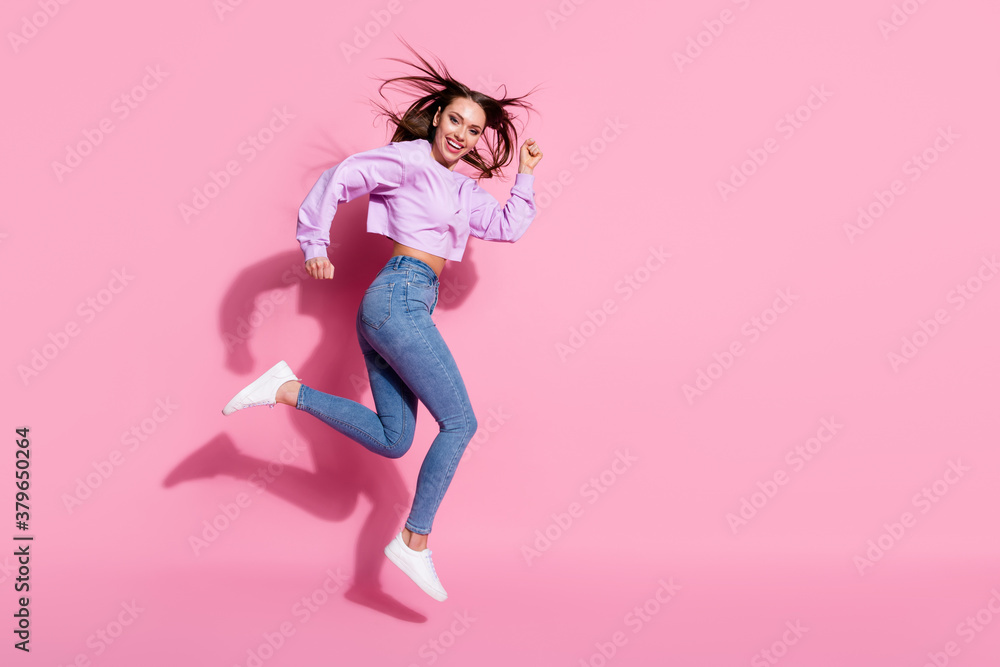 Full size profile side photo of nice cute sweet youth girl listen about discounts jump run copyspace wear style stylish trendy pullover sneakers isolated pastel color background Full size profile side photo of nice cute sweet youth girl listen about discounts jump run copyspace wear style stylish trendy pullover sneakers isolated pastel color background