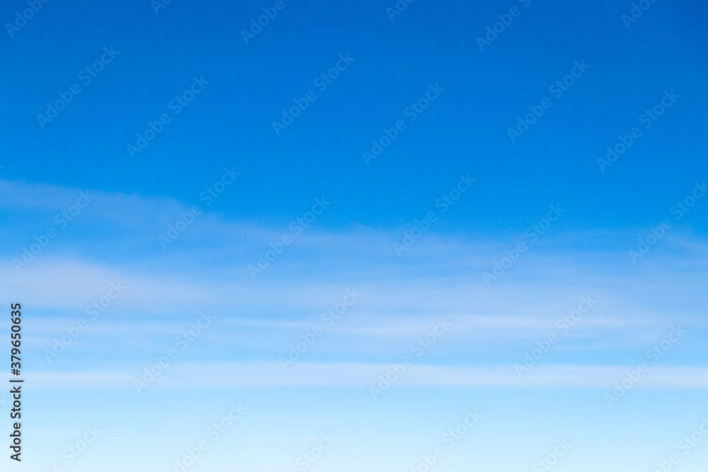 Clear blue sky with white cloud background