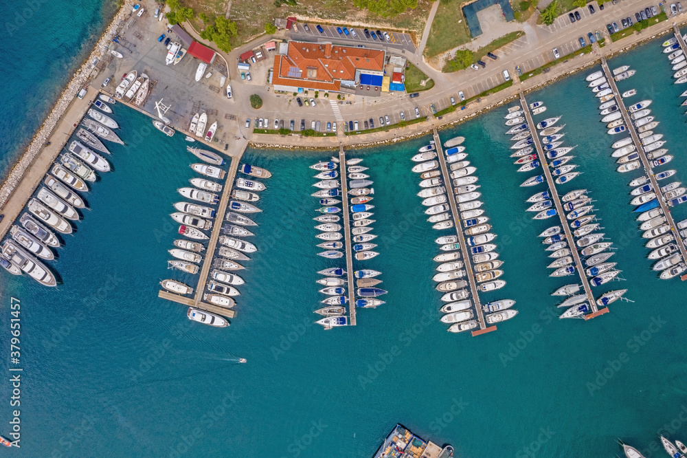 Top view on Vrsar harbour with plenty of ships during daytime with turquoise water