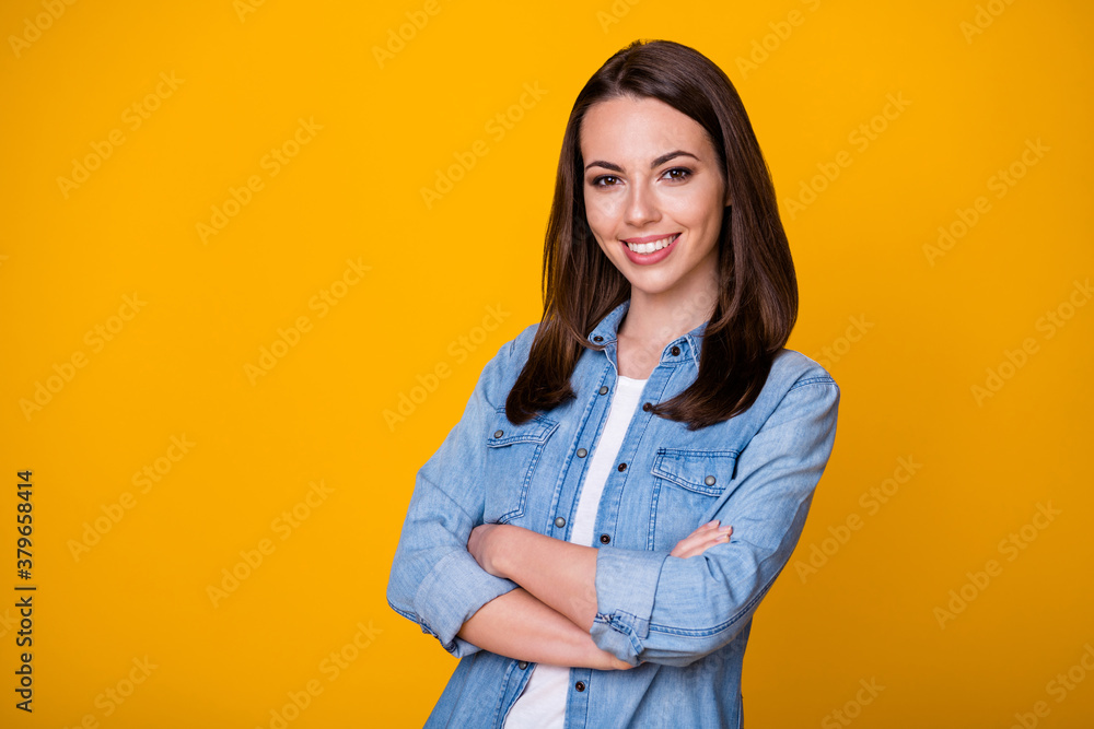 Photo of attractive confident business lady arms hands crossed good mood professional freelancer beaming smile wear casual denim shirt isolated vivid yellow color background Photo of attractive confident business lady arms hands crossed good mood professional freelancer beaming smile wear casual denim shirt isolated vivid yellow color background