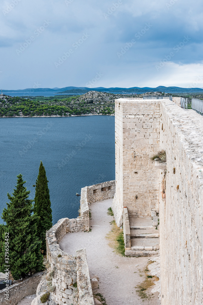 Medieval tower and walls of the fortress on the background of the Adriatic sea and islands on the horizon in Sibenik, Croatia