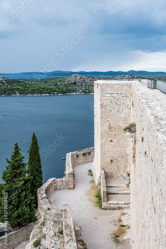 Medieval tower and walls of the fortress on the background of the Adriatic sea and islands on the horizon in Sibenik  Croatia