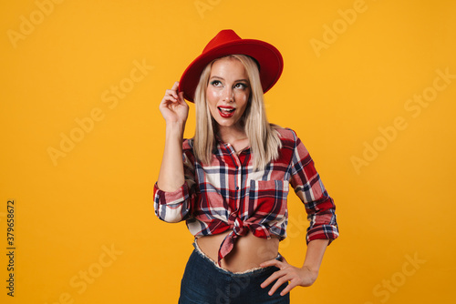 Image of pleased beautiful pinup girl posing in red hat