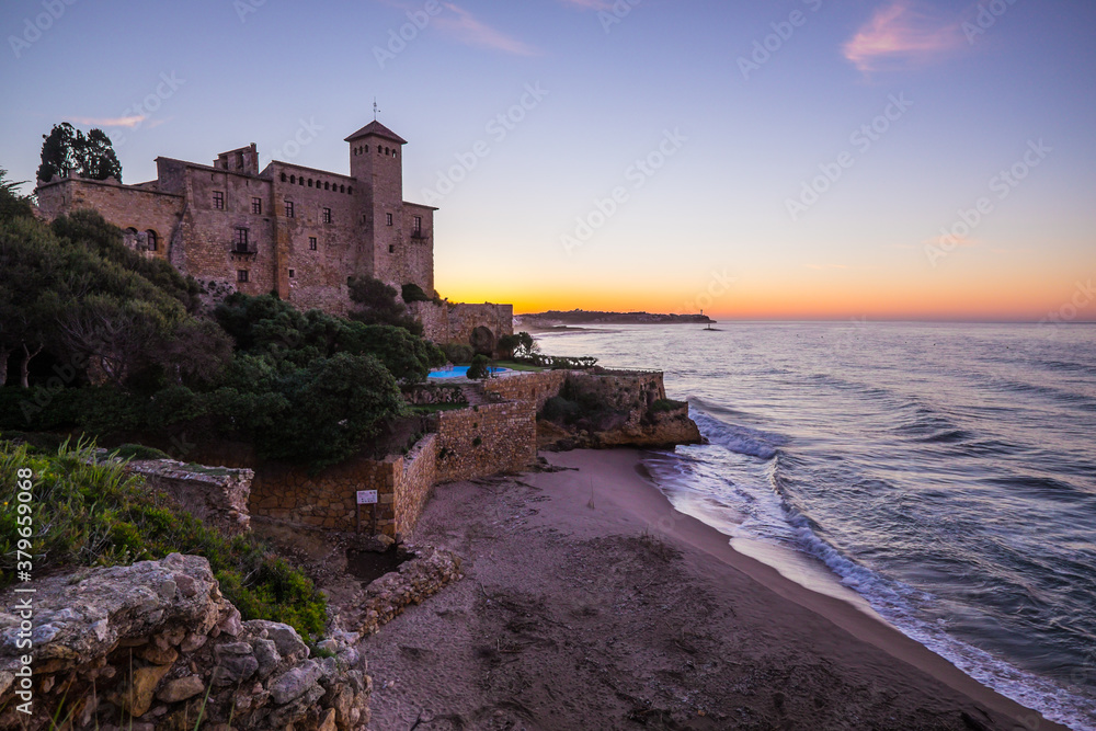 Beautiful sunrise at Castell de Tamarit, near Tarragona, Costa Dorada, Catalonia in Spain. This is a Romanesque style castle, located on a promontory on the shores of the Mediterranean Sea.