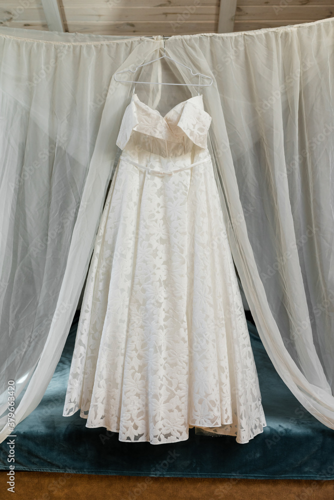 wedding dress hanging inside the room wedding dress hanging inside the room