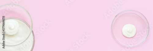 Collagen white powder. Pastel color background. Health product. Woman cosmetics concept. Sport supplement. Skincare cosmetics. Horizontal banner. Pink monochrome. Cream smear