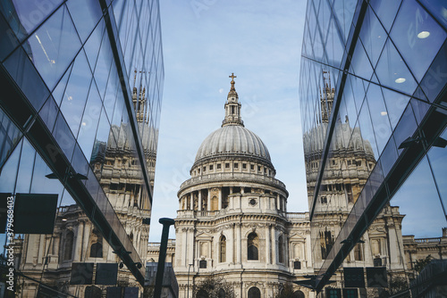 Saint Paul Cathedral reflected in modern glass walls of One New Change mall in City of London, England photo