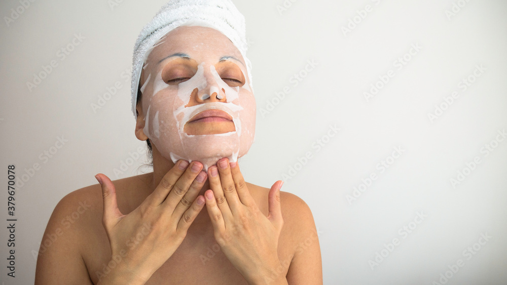 Caucasian  woman apply white cosmetic facial mask. Negative space or copy space for text.