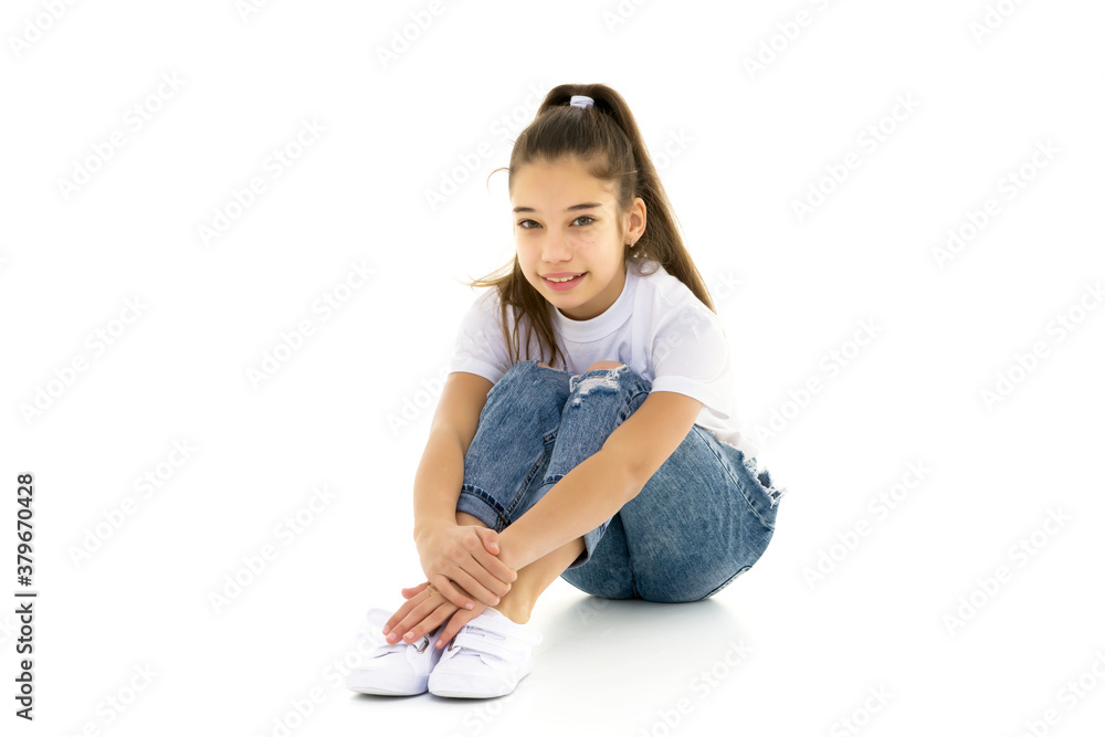 Little girl hugging her knees. sitting on the floor. Stock Photo ...