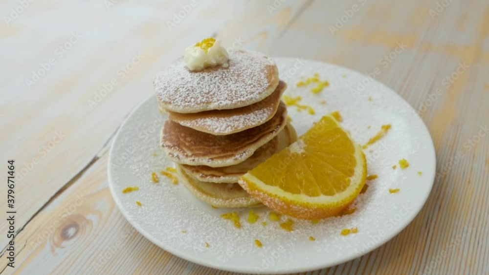 fried pancake with orange on white dish fried pancake with orange on white dish