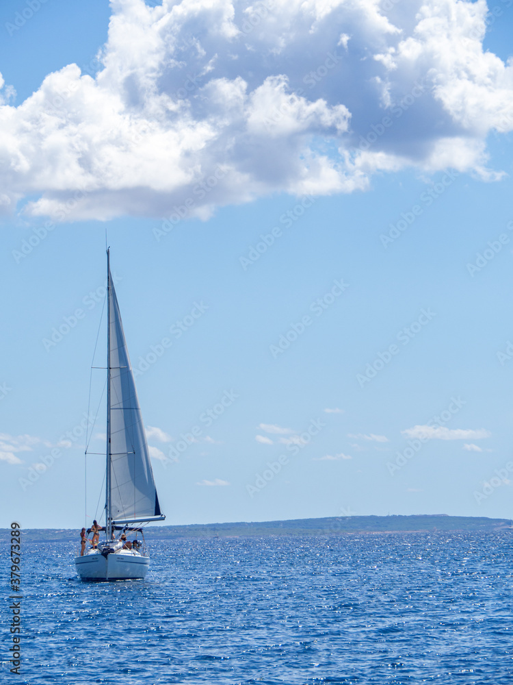 Sailboat anchored at the sea during summer vacation. Fun and adventure vacations in the ocean with friends.