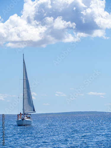 Sailboat anchored at the sea during summer vacation. Fun and adventure vacations in the ocean with friends. © OlgaPS