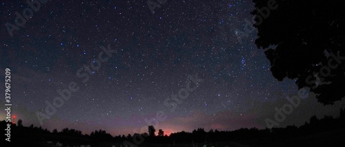 Blue dark night sky with many stars. Night sky over rural landscape. high ISO landscape with fisheye lens