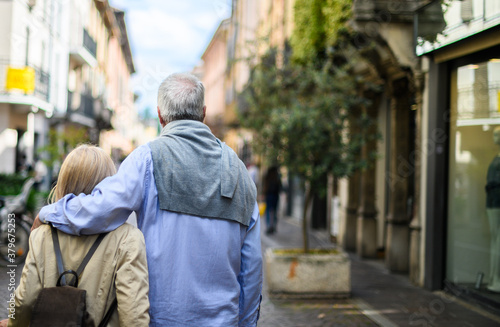 Old dreamy couple carefree walking along the streets of the old city © Minerva Studio