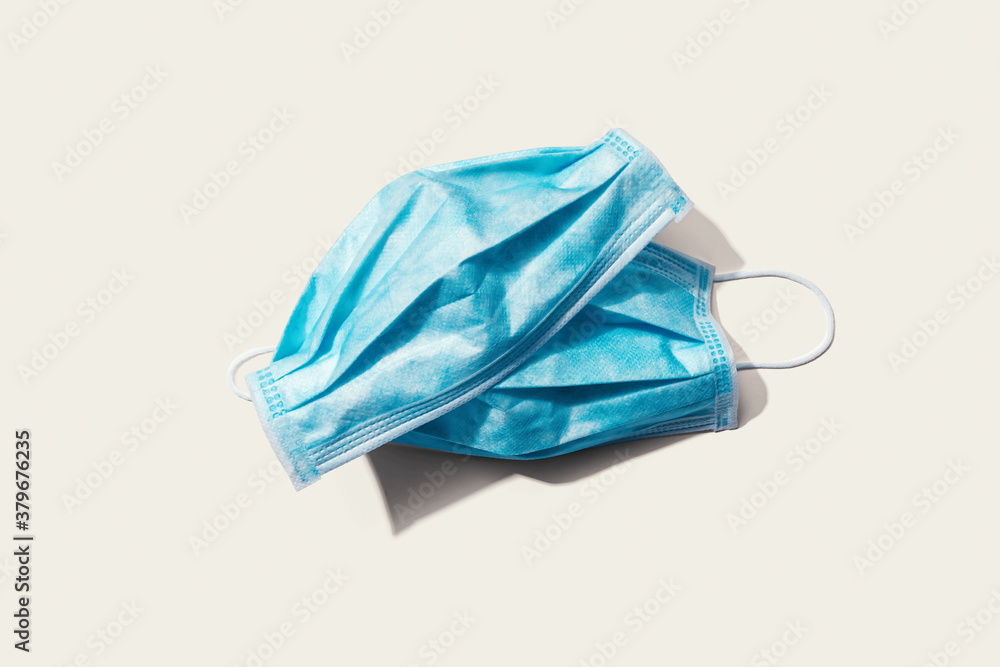 Blue surgical masks overhead view - flat lay Blue surgical masks overhead view - flat lay