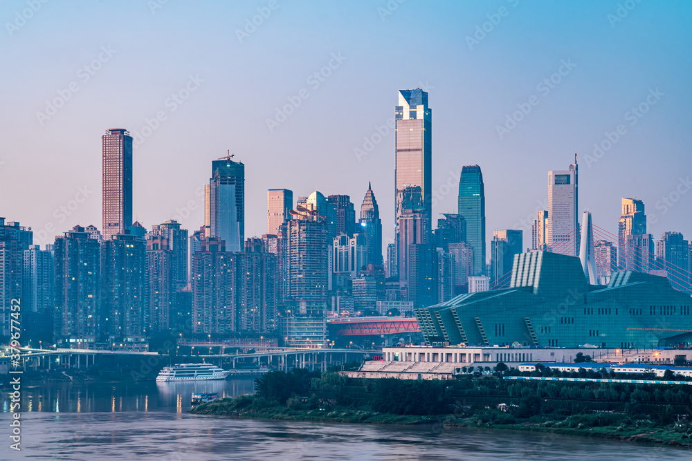 Night view of tall buildings along Chaotianmen in Chongqing, China and Chongqing Grand Theater