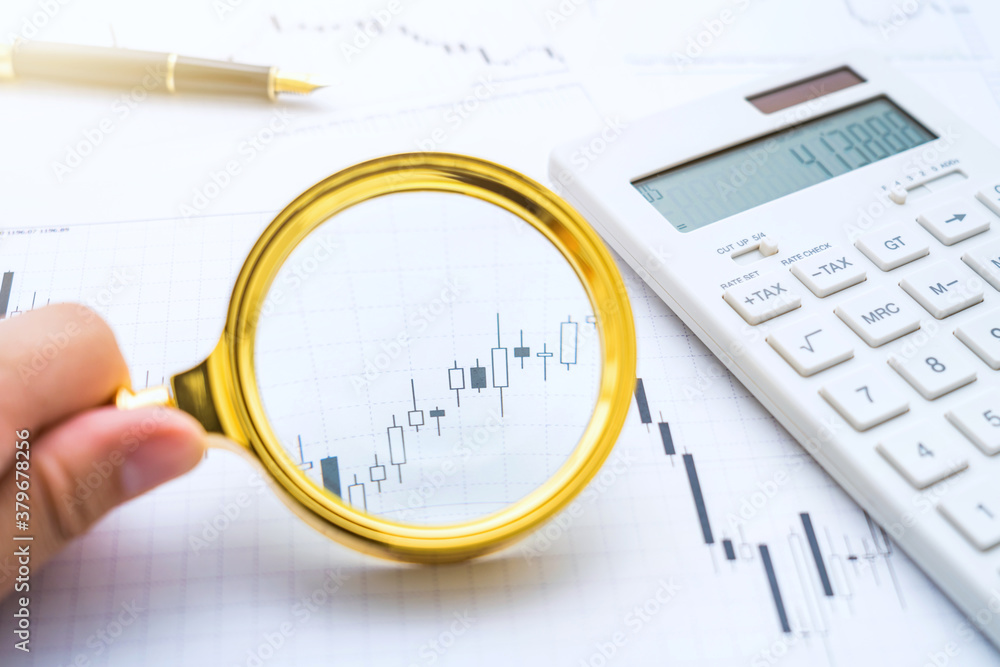 Hold a magnifying glass to view stock trends Hold a magnifying glass to view stock trends