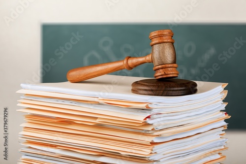 Judge wooden hammer and stack documents