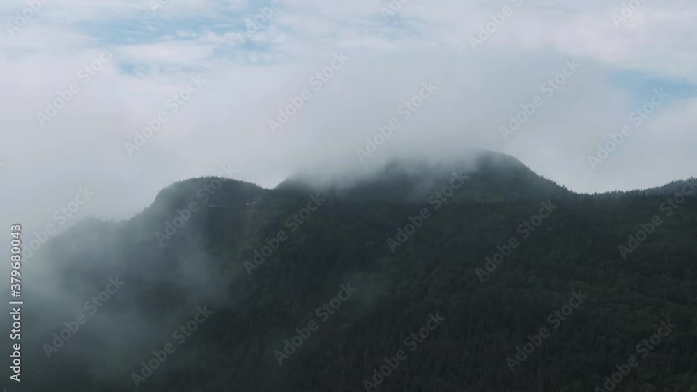 Clouds At The Peak Of The Lush Green Forest In Mont Sainte Anne, Quebec, Canada In Spring - aerial Clouds At The Peak Of The Lush Green Forest In Mont Sainte Anne, Quebec, Canada In Spring - aerial