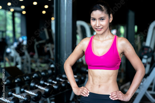 Fitness Asian woman standing for rest after exercise.