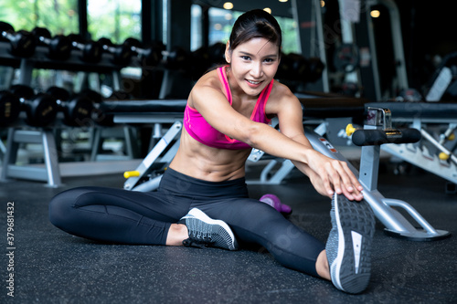 Beautiful Asian woman exercising in fitness.