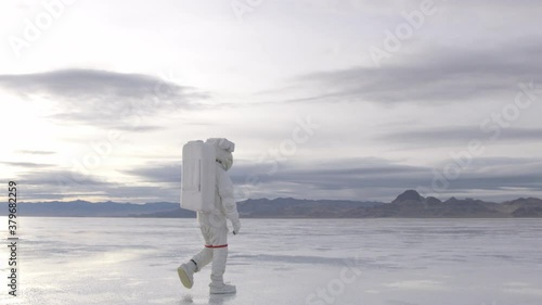 Astronaut Walking on Planet Surface photo