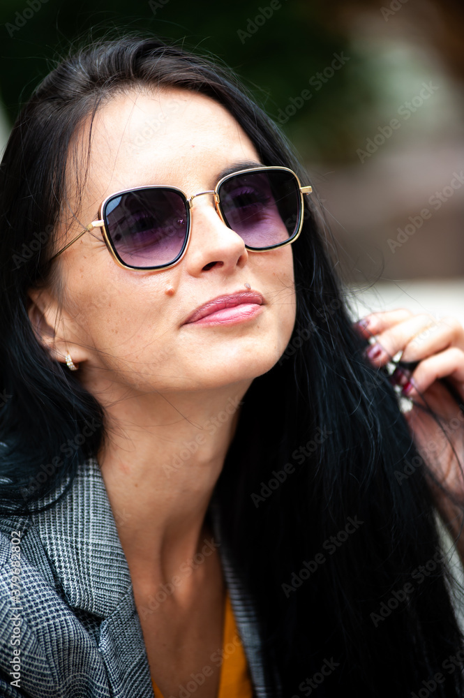 Young beautiful woman in sunglasses in the city Young beautiful woman in sunglasses in the city