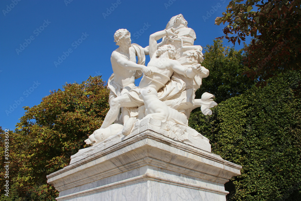 mythological statue (aristaeus and proteus) in a park in versailles (france)