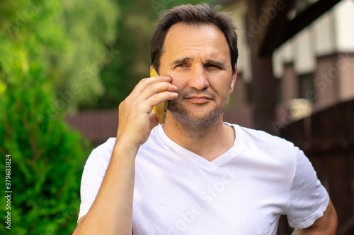 Portrait of happy businessman outdoors with mobile phone. Middle aged confident handsome man makes phone call, talk cellphone, holds smartphone. Online consulting, mobile operator concept, copy space