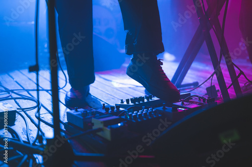 Live Music Concert Guitar Equipment Pedal Board, Purple and Blue Stage Lights, Wooden Floor