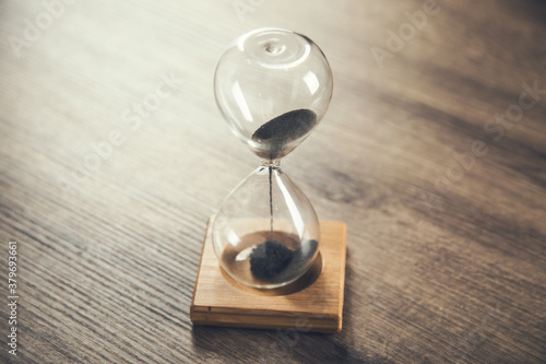 hourglass stand on a wooden table