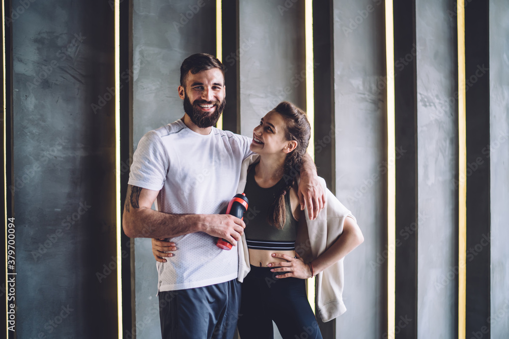 Positive young male and female couple in love enjoying training together  keeping perfect body shape and physical vitality, smiling hipsters  boyfriend and girlfriend satisfied with workout results Photos | Adobe Stock