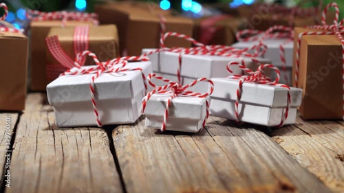 Christmas gifts, pan on old wooden table, bokeh lights