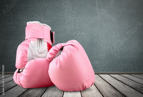 Sport pink boxing gloves on the desk