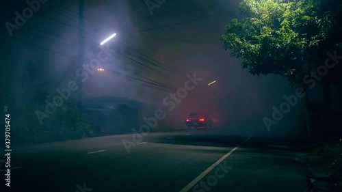 Classic car drive into abandoned road with large of smoke photo