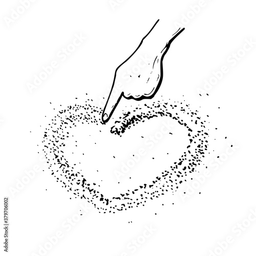 Hand draws a heart in the sand