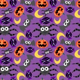 Halloween funny cartoon characters vector seamless pattern. Simple happy spiders, bats, pumpkins, moons and candies on violet background endless texture. One of a series.