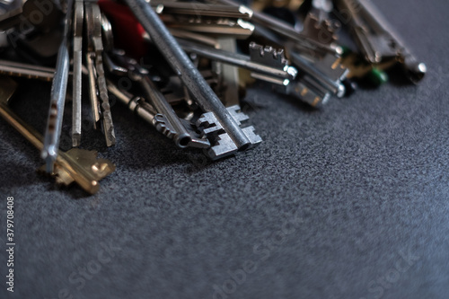 Large pile of different keys on gray background