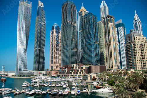Stunning panoramic view of Dubai Marina skyline, yachts and boats moored at the pier on a bright sunny day. Dubai, United Arab Emirates. © SeaRain