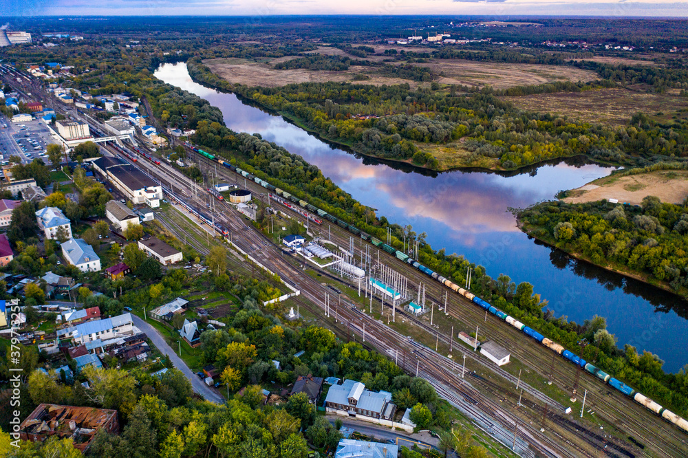 Fototapeta premium panoramic view of the motorway across the river against the backdrop of a green forest