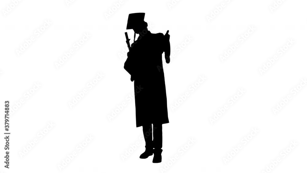 Silhouette Happy male student in graduation robe posing with his diploma and showing thumbs up. Silhouette Happy male student in graduation robe posing with his diploma and showing thumbs up.