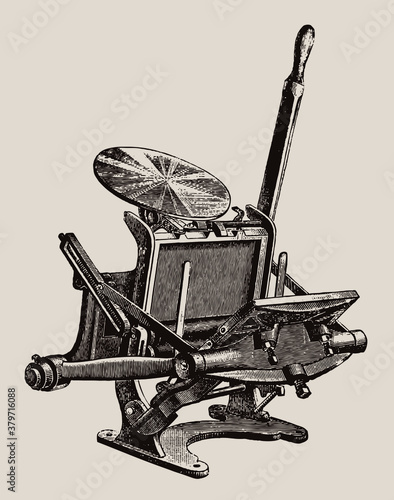 Antique hand-operated platen printing press in three quarter view, isolated on a light brown background