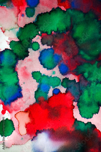 Ink drops on the paper, red, green and blue ink splashes background