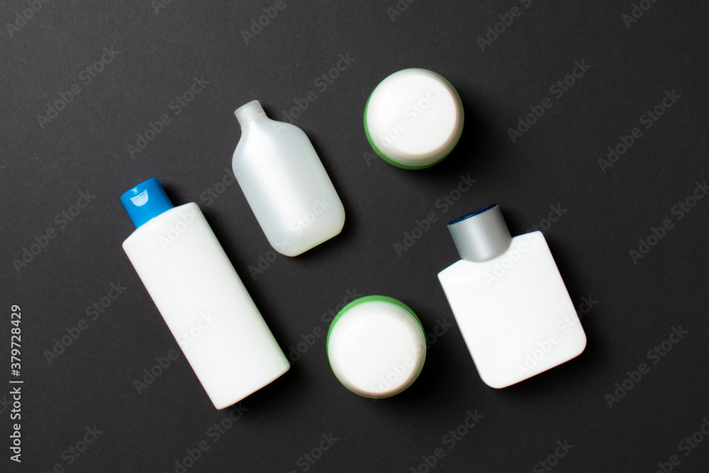 Cosmetics SPA branding mock-up, top view with copy space. set of tubes and jars of cream flat lay on colored background Cosmetics SPA branding mock-up, top view with copy space. set of tubes and jars of cream flat lay on colored background