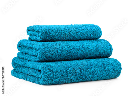 a set of plain smooth-colored cotton towels, folded in a pyramid, isolate on a white background