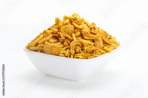 Mixture chivda Indian snacks or namkeen in white bowl in white background.