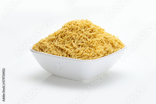 Indian snacks bhujiaa sev in white bowl in white background.