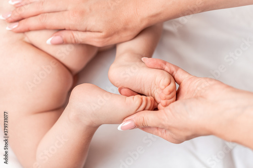 Close-up Foot massage for baby. Mother makes massage for happy, Health care concept